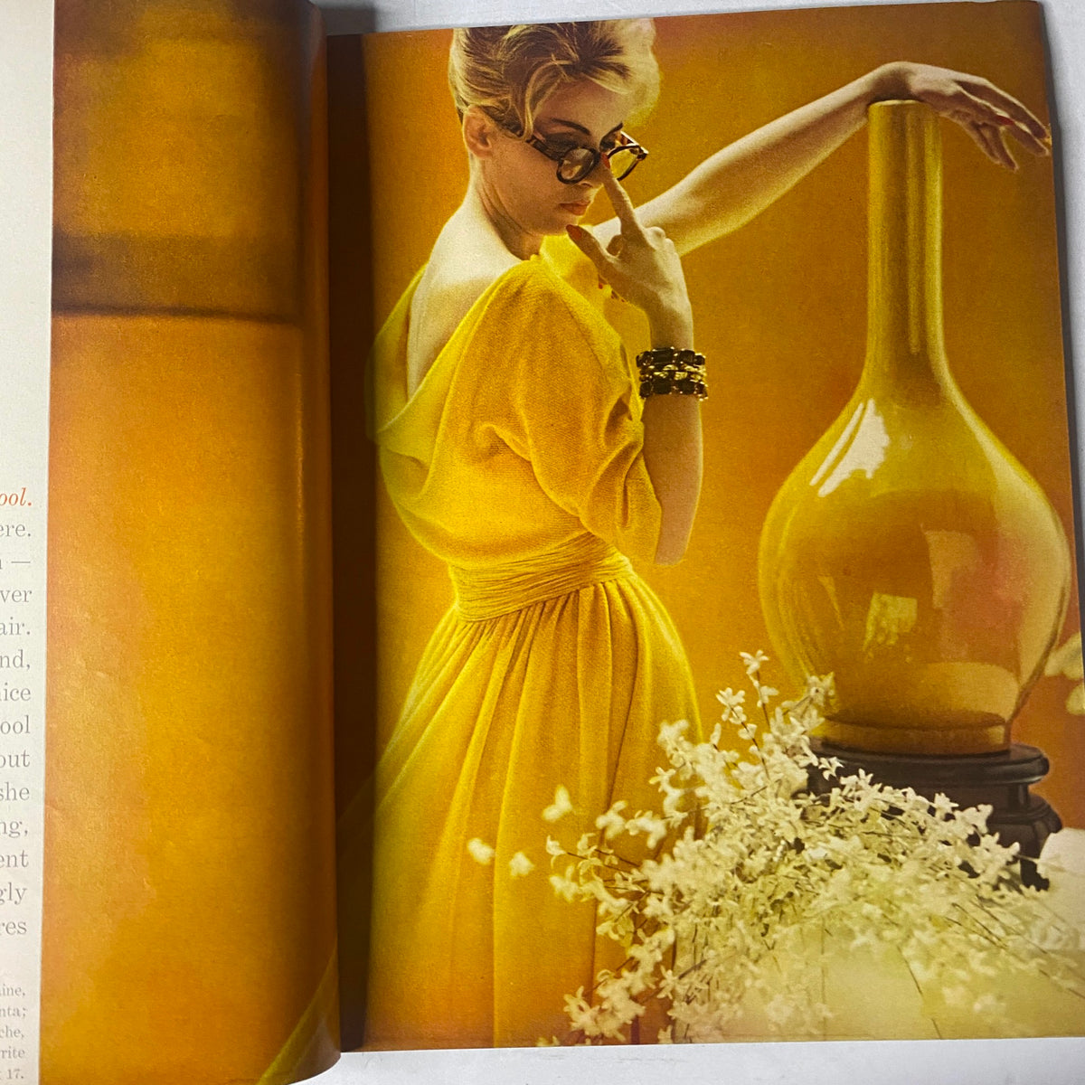 A vibrant fashion spread from Vogue Magazine January 15, 1961, showcasing a model in a yellow dress with sunglasses, reflecting the stylish looks of the early 1960s.