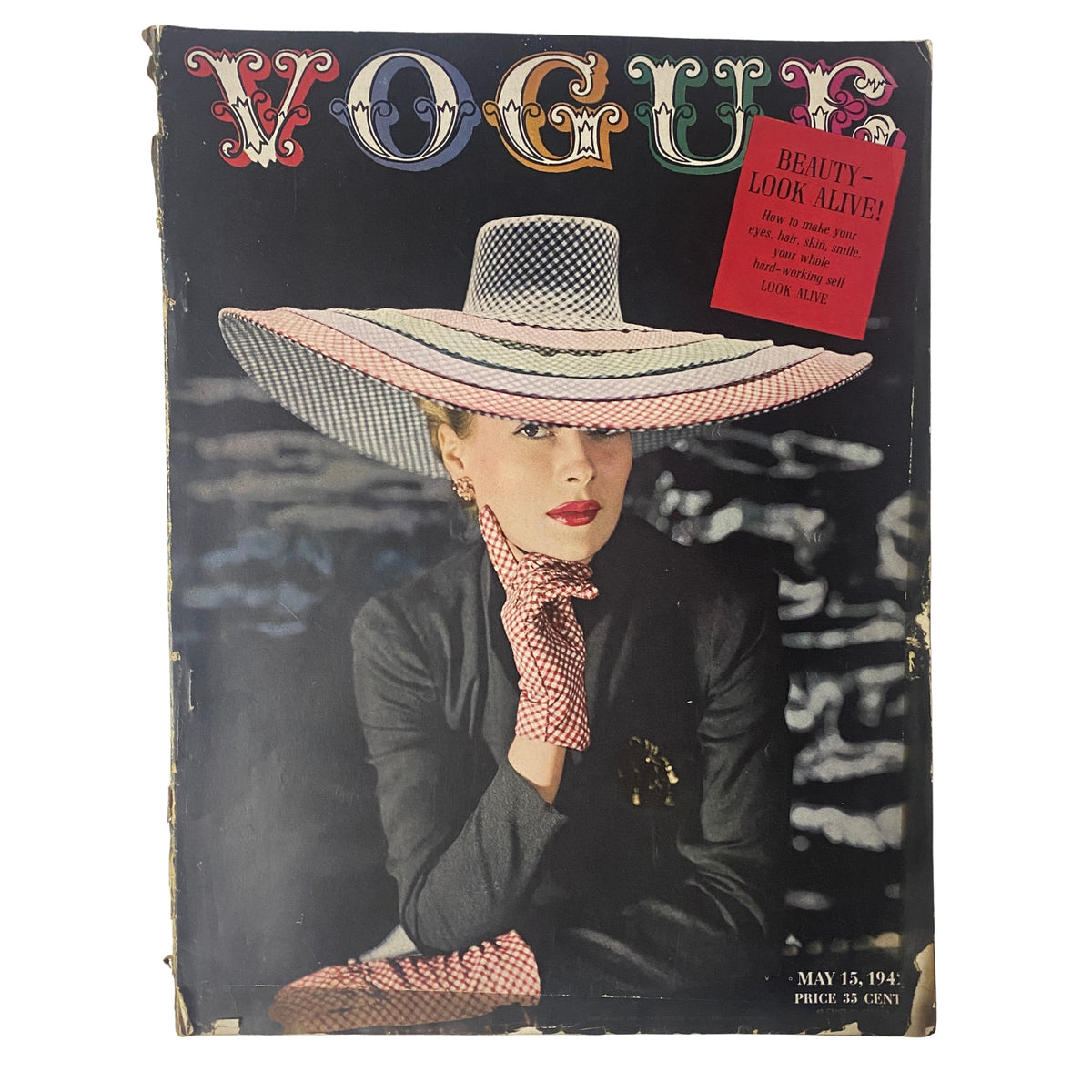 Cover of Vogue Magazine May 15, 1942 featuring Maureen Zollman in a stylish hat, captured by John Rawlings, highlighting wartime fashion and beauty.