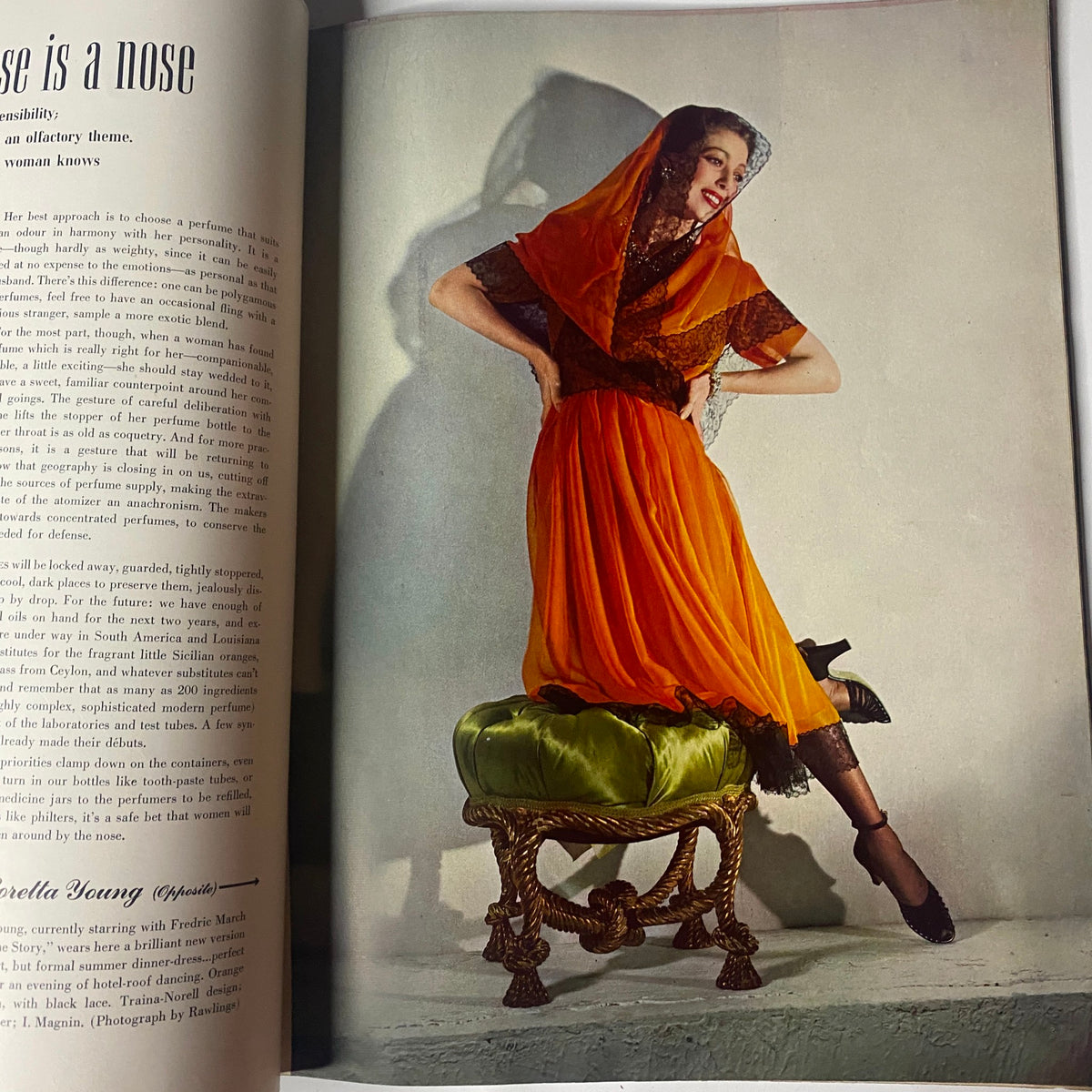 Fashion editorial from Vogue Magazine May 15, 1942, depicting a model dressed in a striking orange gown, emphasizing the artistic photography of the era.