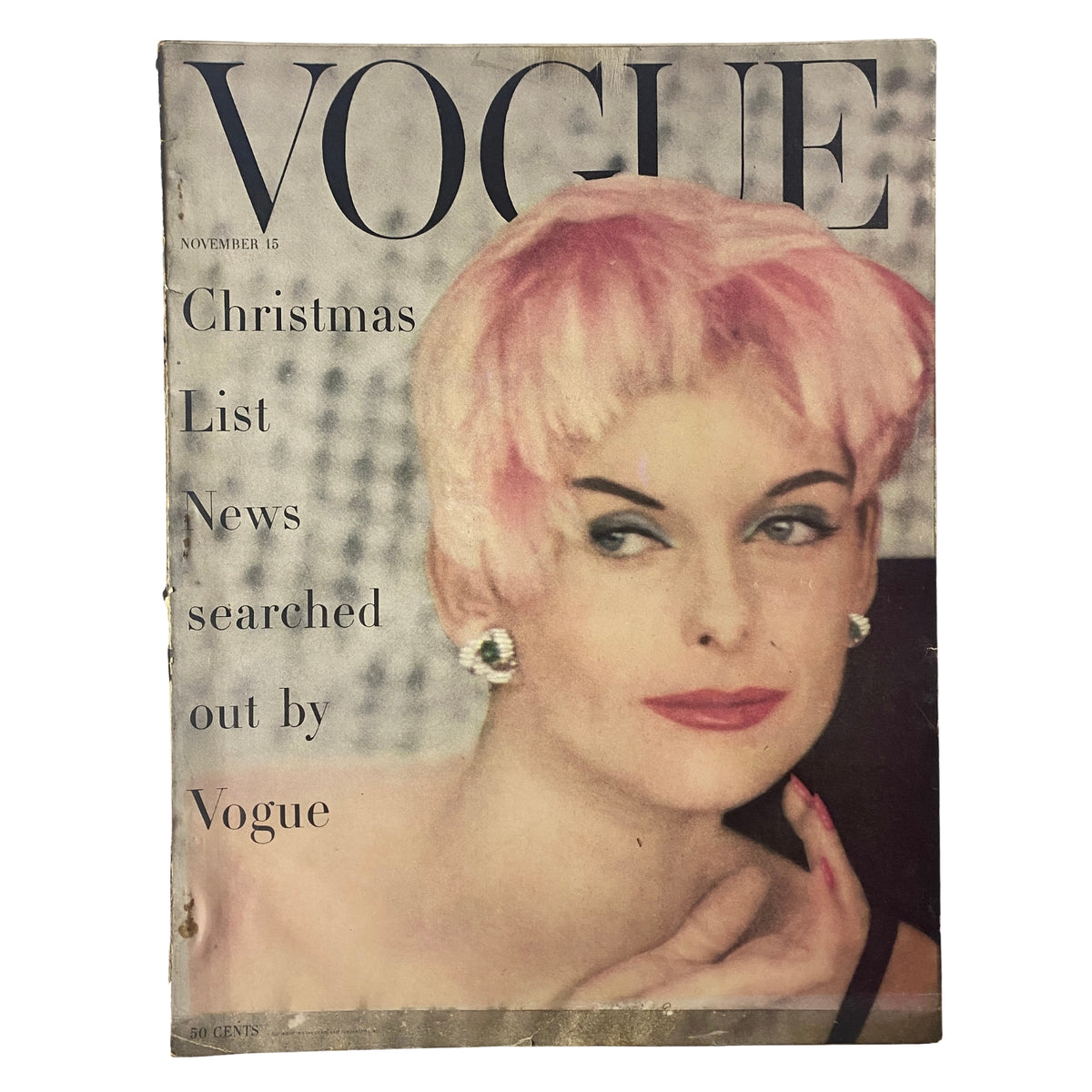 Cover of Vogue Magazine from November 15, 1955 featuring Anne St. Marie. The cover showcases a glamorous woman with pink hair and bold makeup, highlighting Christmas gift ideas from Vogue.