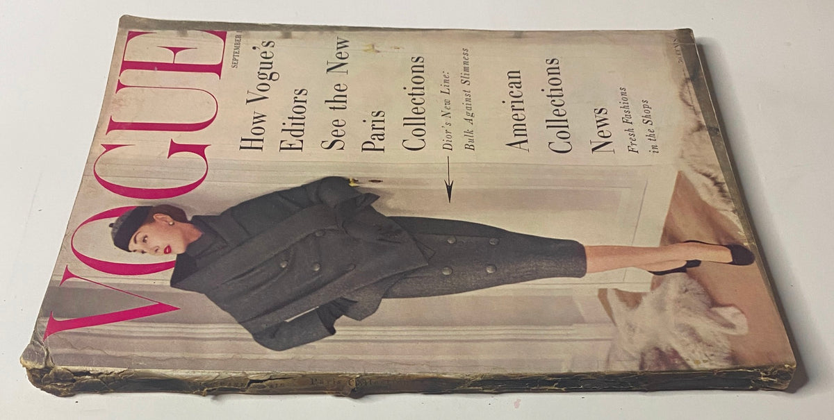 Vogue Magazine September 1, 1955 cover featuring Renée Breton, photographed by Henry Clarke. The magazine presents an overview of the Paris collections with an emphasis on the structure in fashion, displayed by a model in a stylish gray coat.