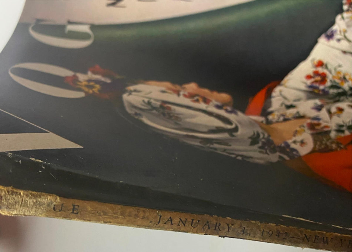 Close-up of the spine detail of Vogue Magazine January 1, 1942 Sandy Rice Cover by John Rawlings, revealing the date and magazine title. The unique vintage character of the magazine is highlighted.