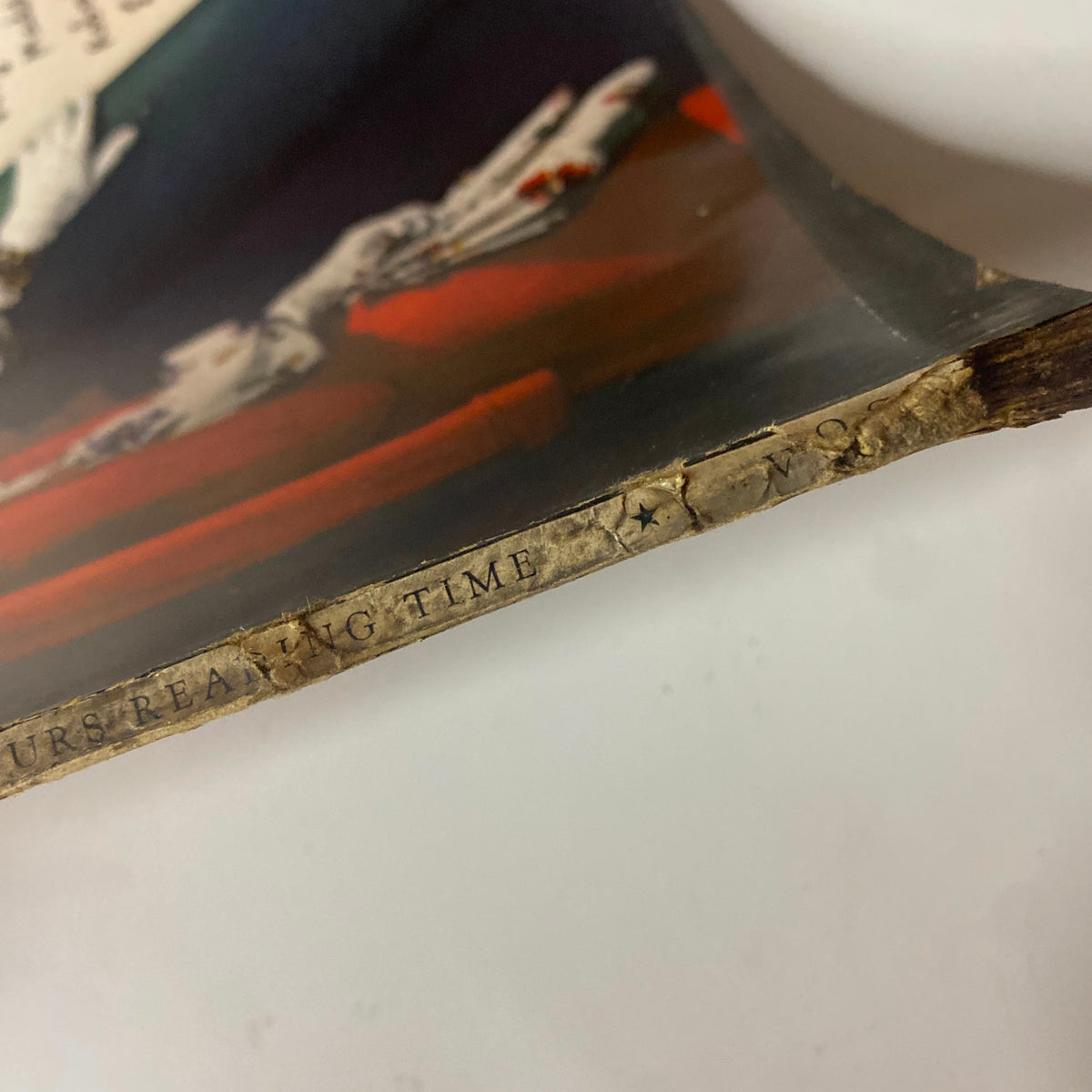 Close-up of the bottom spine detail of Vogue Magazine January 1, 1942 Sandy Rice Cover by John Rawlings, indicating the edition's reading time. The vintage texture adds to the historical significance of this issue.