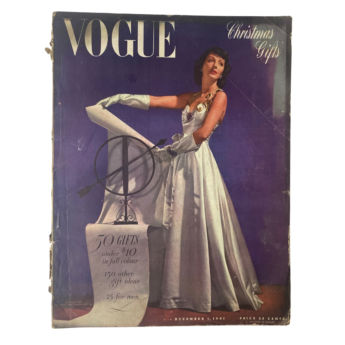 Vogue Magazine December 1, 1941 cover featuring Betty McLauchlen in a glamorous gown, highlighting Christmas gifts, photographed by John Rawlings.