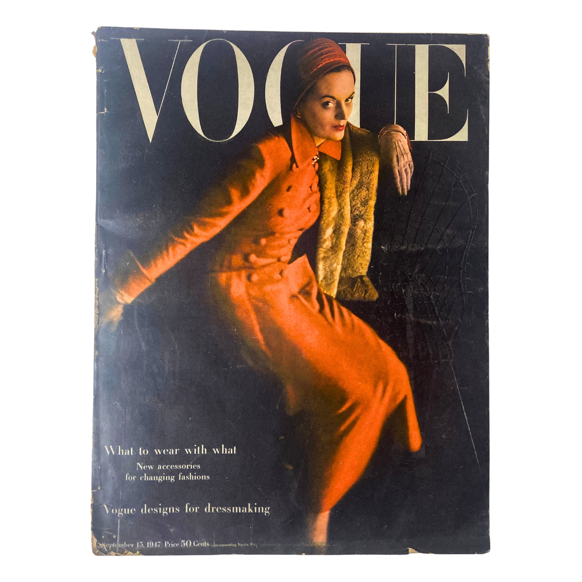 Cover of Vogue Magazine from September 15, 1947 featuring an elegant model in a red coat and fur accessory, photographed by Richard Rutledge. The issue focuses on postwar fashion trends and accessories.