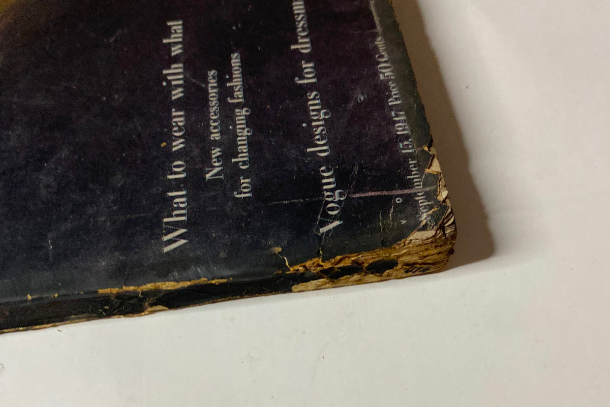Detailed image of the back cover of Vogue Magazine from September 15, 1947. The cover features fashion guidance and highlights for readers, with visible signs of age and handling.