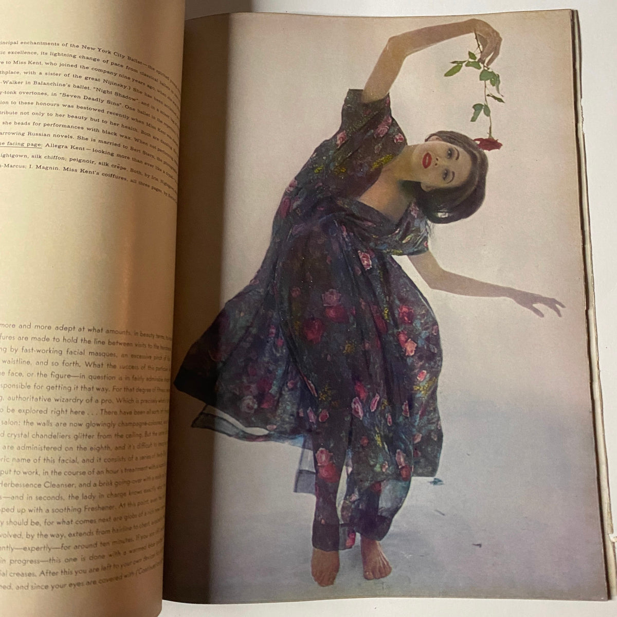Vintage photo from Vogue Magazine November 15, 1961 featuring a model gracefully posing in a flowing floral dress, exemplifying mid-century fashion trends.