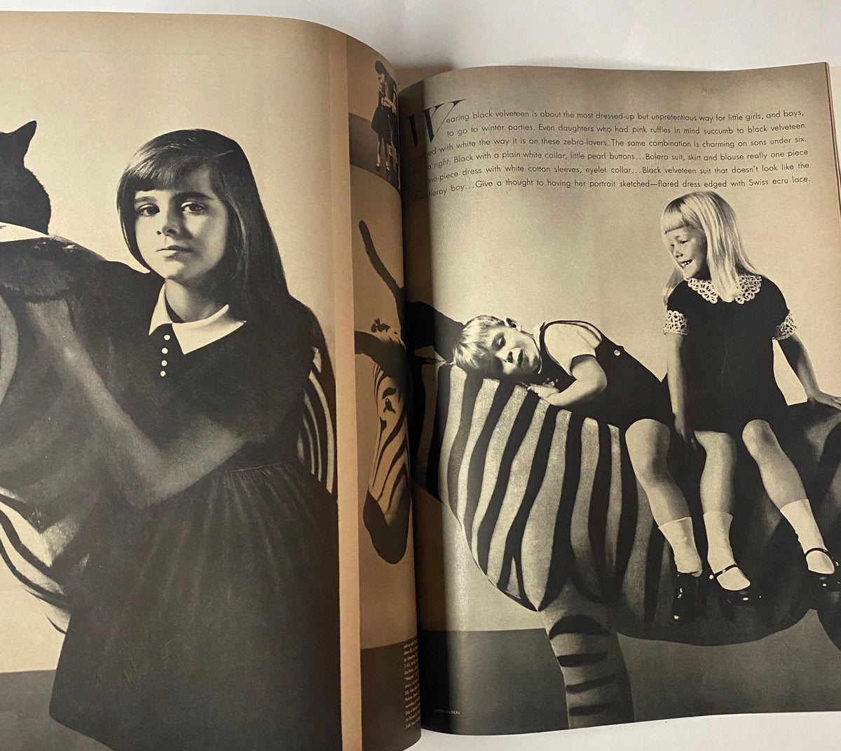 Artistic photo from Vogue Magazine November 15, 1961 capturing children and animals in a candid moment, reflecting the playful aesthetics of mid-century photography.