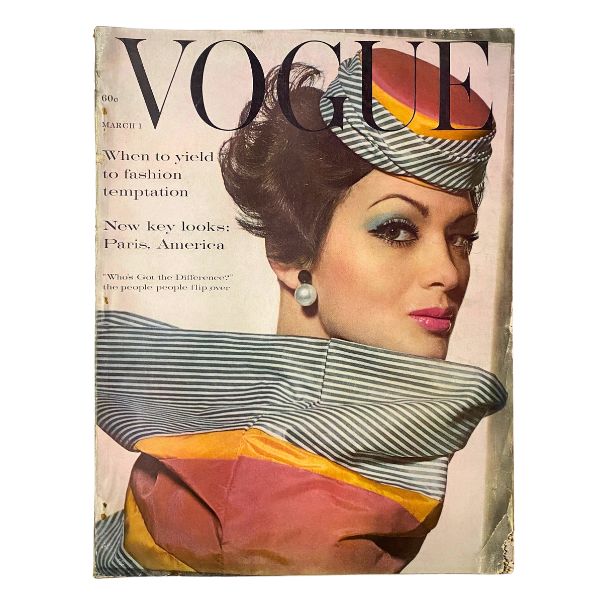Cover of Vogue Magazine March 1, 1961 featuring Isabella Albonico, with a striking hat and bold makeup, photographed by Irving Penn.