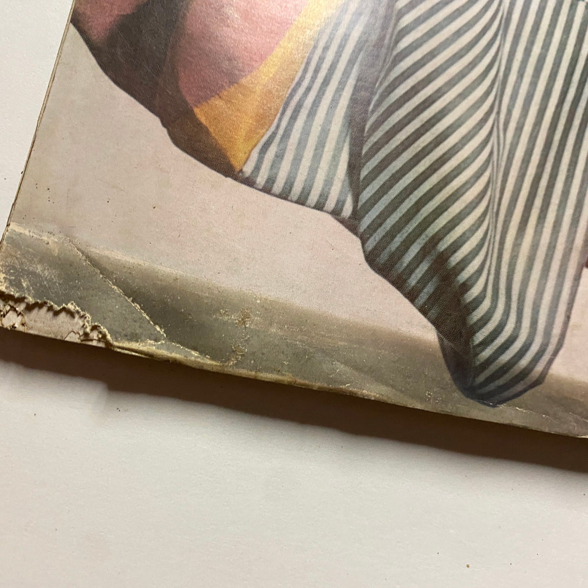Detailed shot of the edge of Vogue Magazine March 1, 1961, showing wear and age, featuring Isabella Albonico on the cover, photographed by Irving Penn.