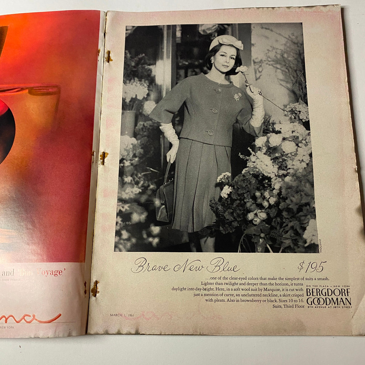 Page from Vogue Magazine March 1, 1961 displaying a stylish model in a gray ensemble by Bergdorf Goodman, advertising 'Brave New Blue' dress.