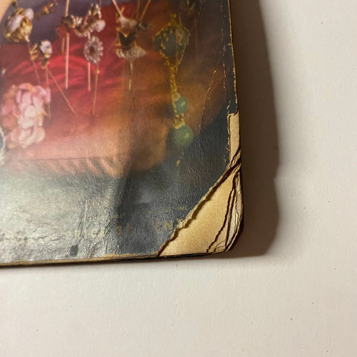 Image showing the damaged edge and tear on the Vogue Magazine May 1, 1938 Cover by Anton Bruehl, with visible wear and age.
