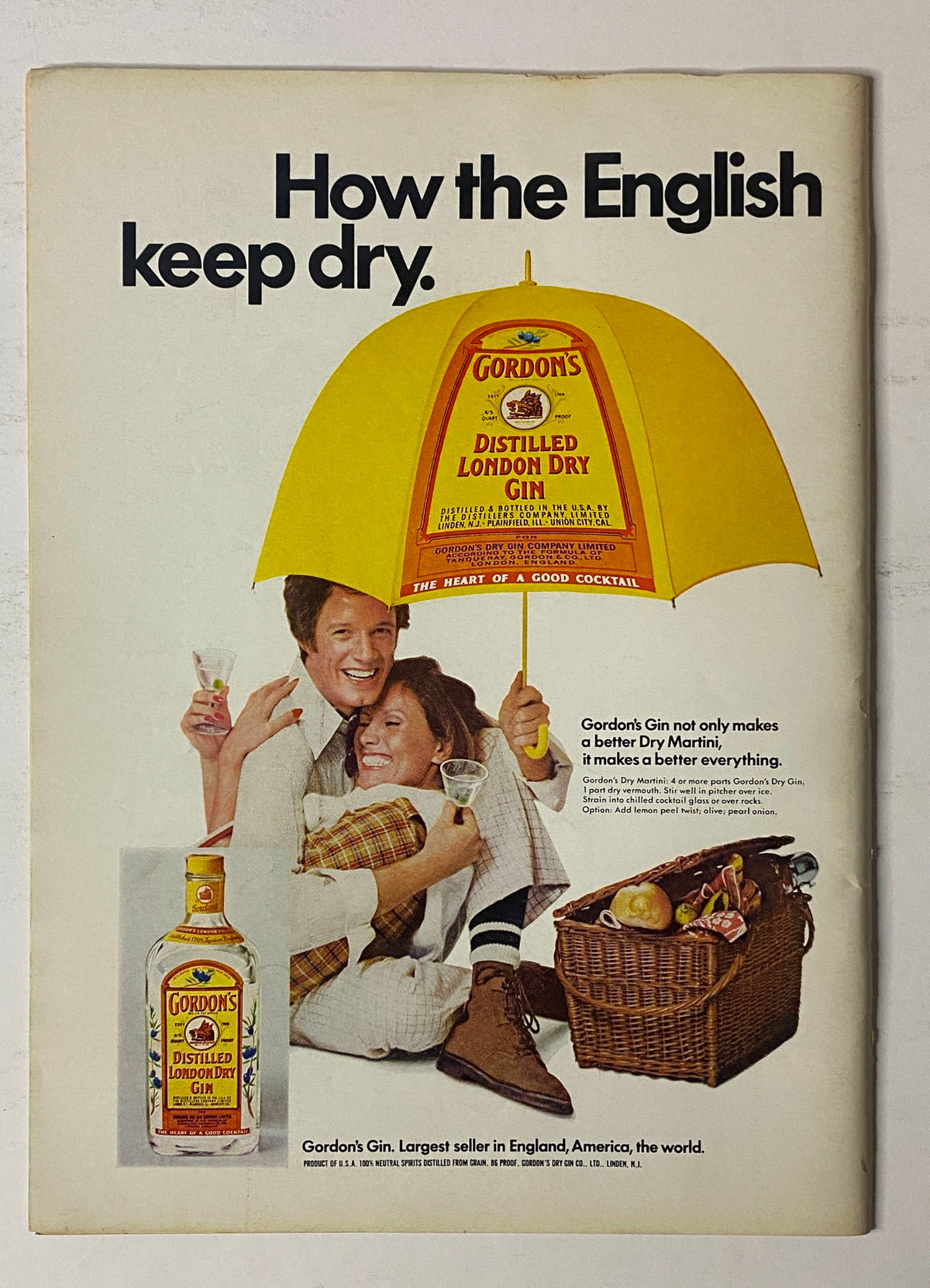 Advertisement for Gordon's Gin featuring a man and woman enjoying cocktails under a large yellow umbrella. The text reads 'How the English keep dry.' This image is part of the vintage advertisements collection, showcasing the memorable marketing strategies of the past.