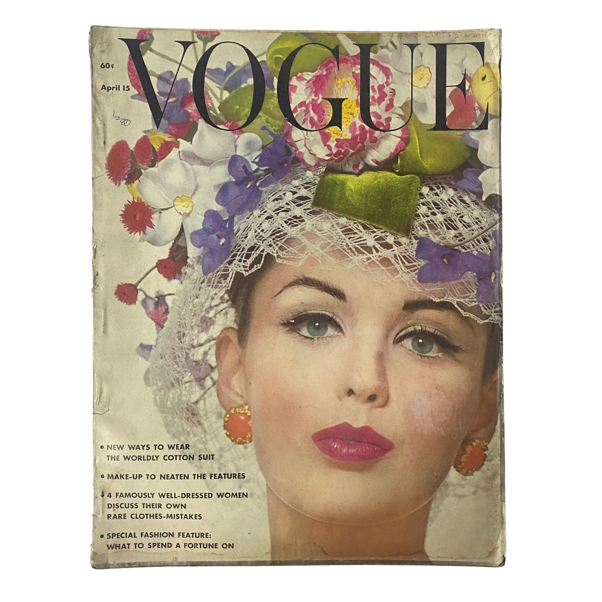 Cover of Vogue Magazine April 15, 1962 featuring model Dorothy McGowan by Bert Stern, with floral embellishments and a stylish headdress.