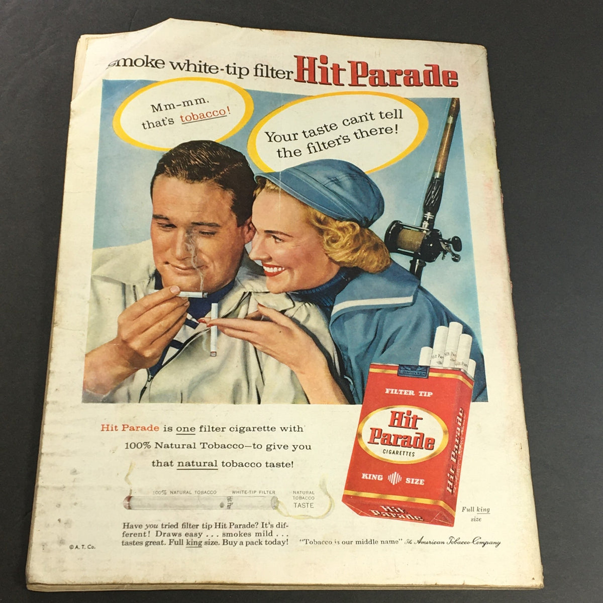Back cover of a vintage Newsweek magazine from June 3, 1957 with an advertisement for Hit Parade cigarettes, featuring a smiling couple engaging with a cigarette.
