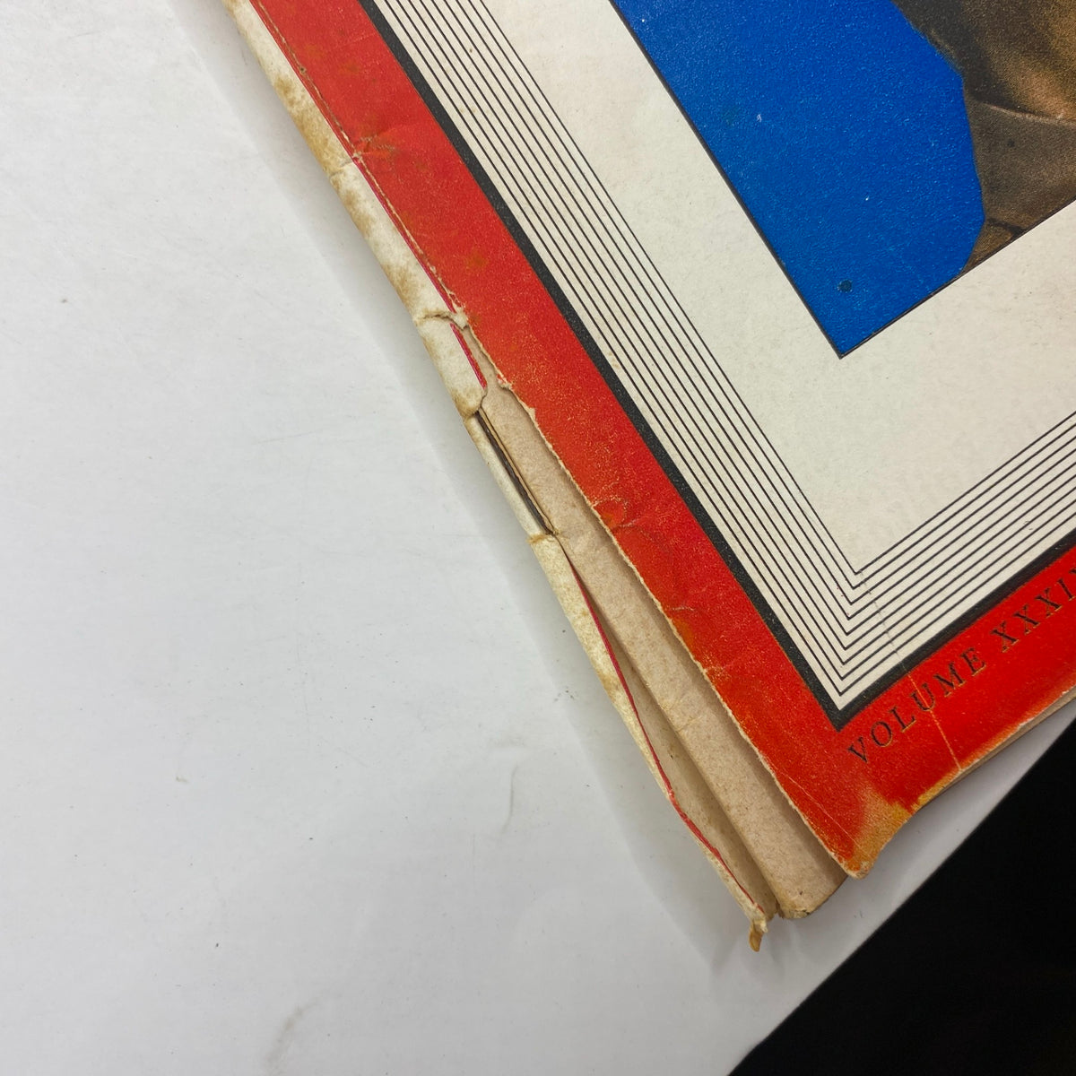 Close-up view of the spine and edge of a vintage Time Magazine from March 30, 1942 featuring Australia's Douglas MacArthur, showcasing its aging condition and colorful cover design.