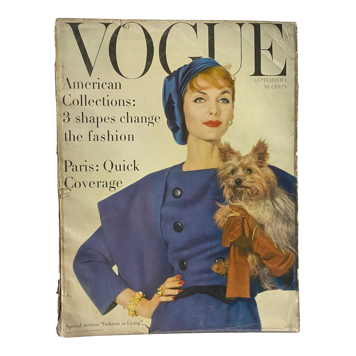 Cover of Vogue Magazine September 1, 1957 featuring Anne St. Marie styled in elegant fashion with a blue coat and hat, holding a Yorkshire Terrier, showcasing the latest trends in fashion.