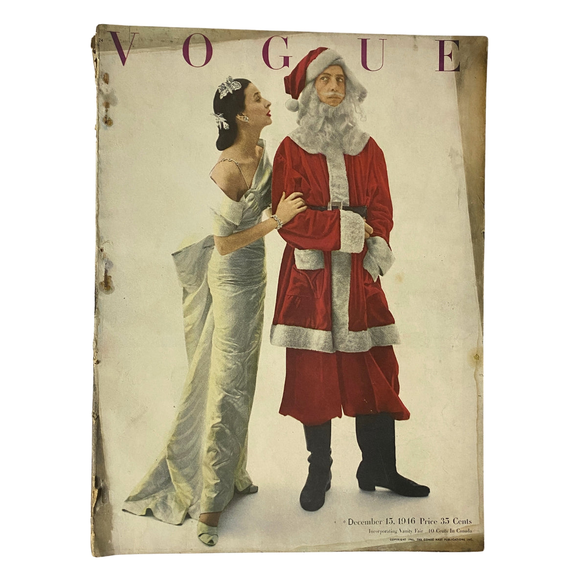 Cover of Vogue Magazine dated December 15, 1946 featuring models in festive attire, with one in an elegant gown and another dressed as Santa Claus, showcasing the seasonal fashion themes of the postwar era.