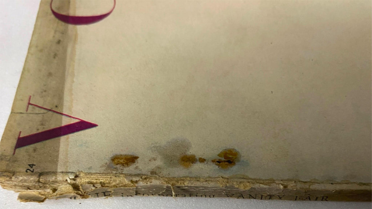 Close-up of the edge of the December 15, 1946 Vogue Magazine, showing signs of wear including stains and slight damage, indicative of the vintage nature of the publication.