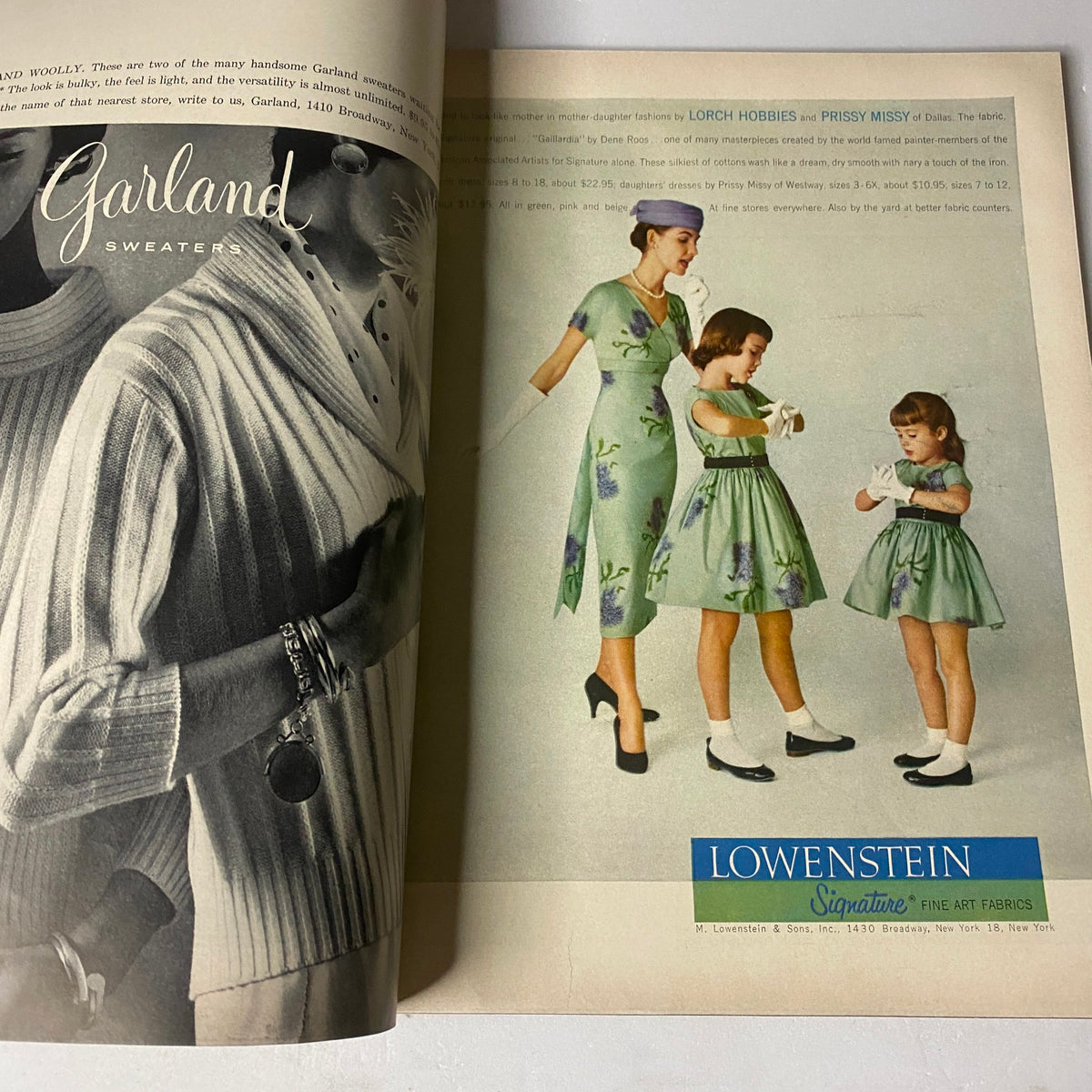 Vogue Magazine February 1, 1957 displaying a glamorous advertisement for Garland sweaters, featuring a model and two young girls in matching dresses.
