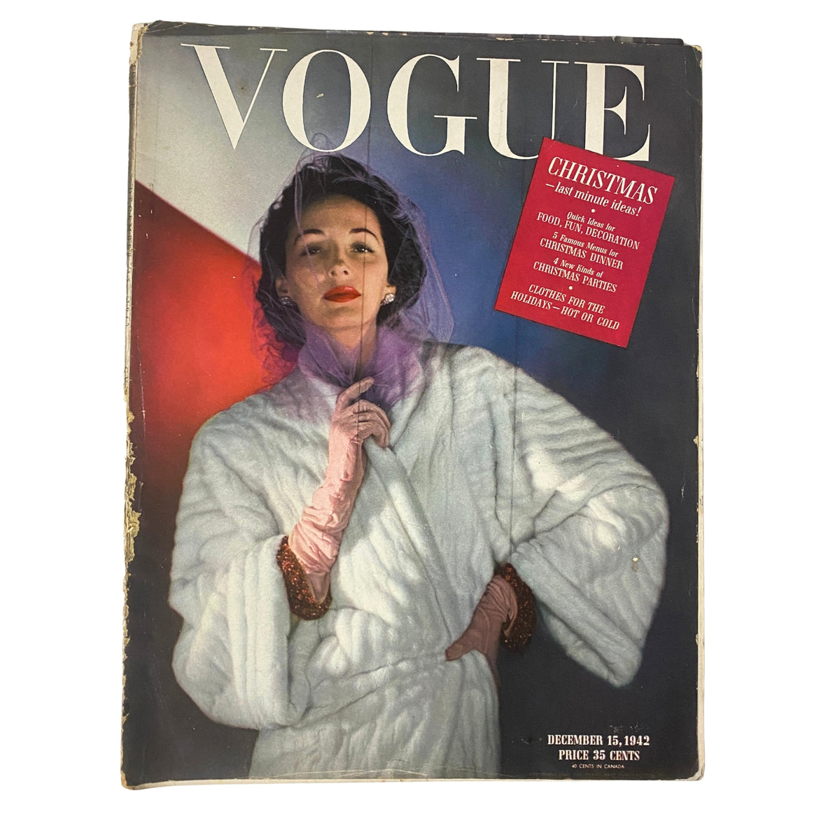 Vogue Magazine cover from December 15, 1942, featuring a model in a luxurious white fur coat, highlighting the theme 'Christmas - Last Minute Ideas,' and showcasing festive fashion.