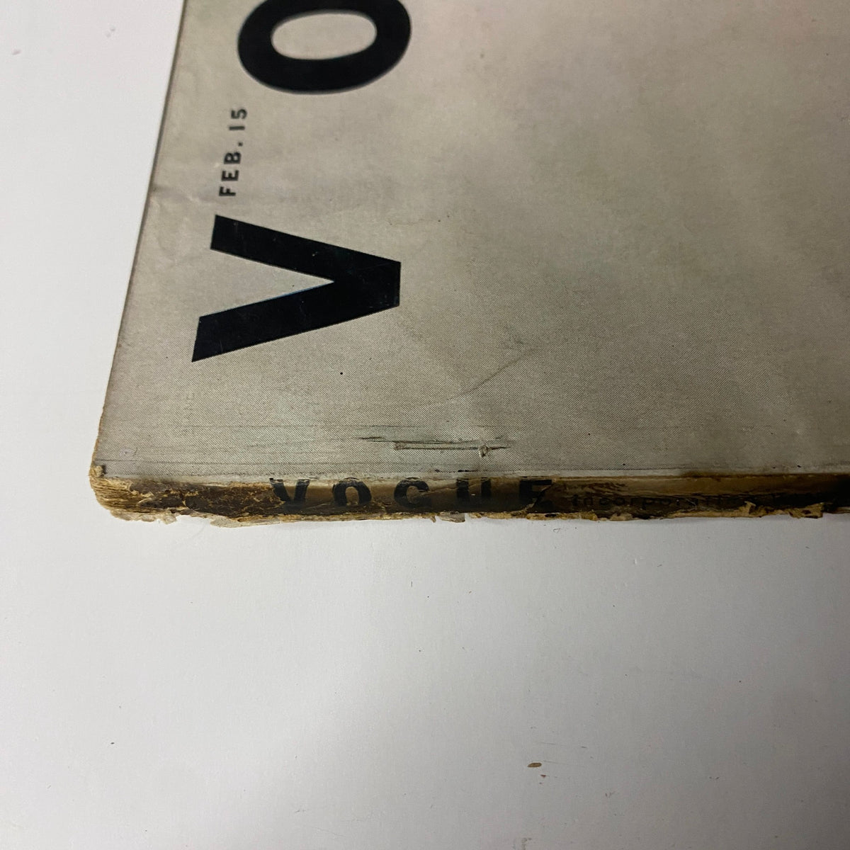 Side view of Vogue Magazine February 15, 1952 showing the spine. The magazine's title is partially visible, indicating its vintage status and significance in fashion history.