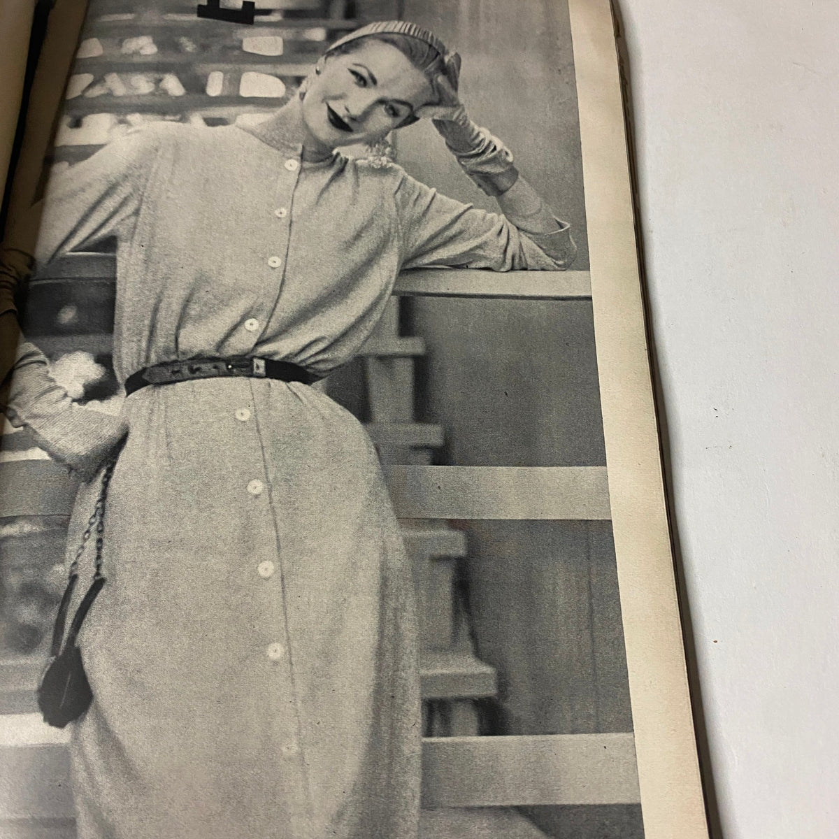 Ruth Neumann wearing a stylish buttoned dress in Vogue Magazine August 15, 1952 issue, photographed by Richard Rutledge.