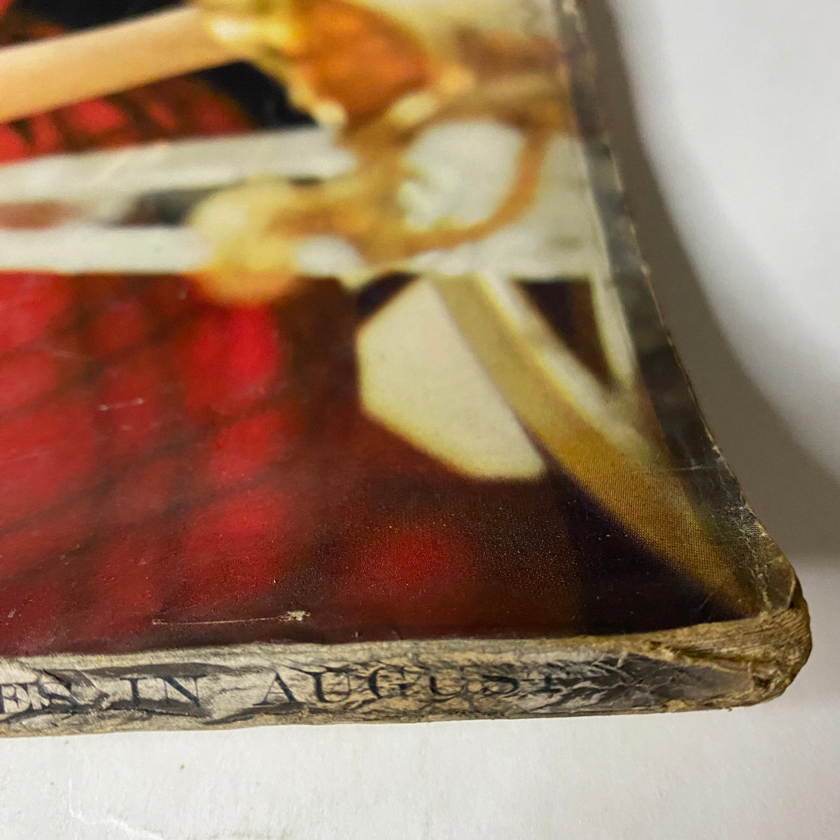Detailed view of the edge of Vogue Magazine August 15, 1957, indicating age with minor wear on the cover.