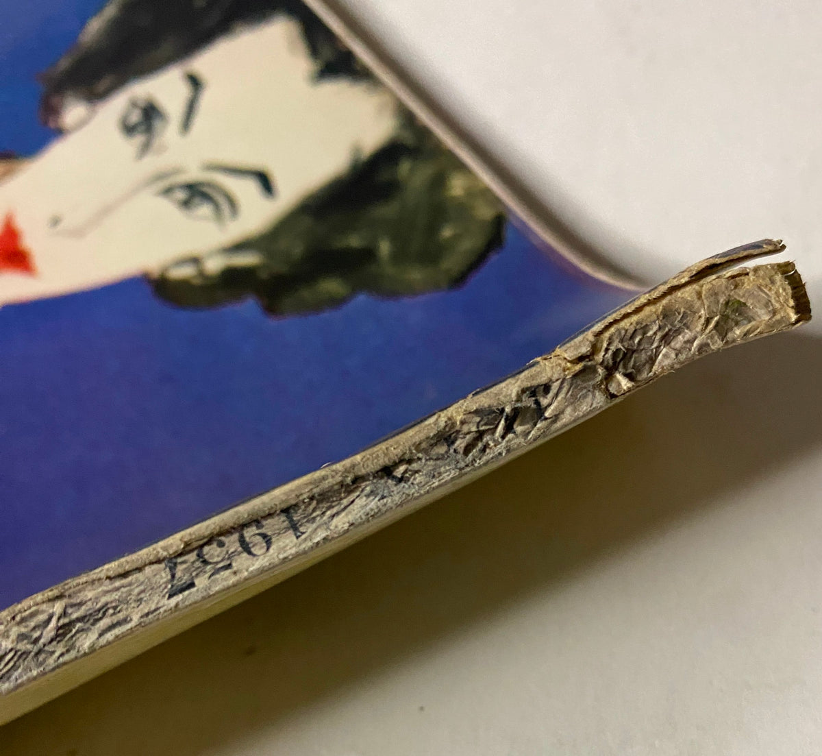 Vogue Magazine July 1957 Joanna McCormick Cover by Karen Radkai showing the spine of the vintage magazine, highlighting the wear and tear indicative of its age.