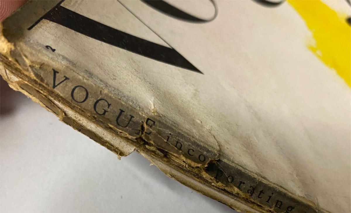 Close-up view of the spine of Vogue Magazine January 15, 1944 Spring Hats Articles Cover by Carl Erickson, showing wear and details of the publication's binding.