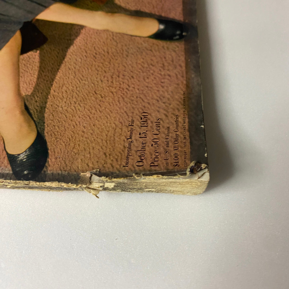 Close-up of the bottom corner of Vogue Magazine October 15, 1950 Jean Patchett Cover by Horst P. Horst, highlighting the publishing date and price.