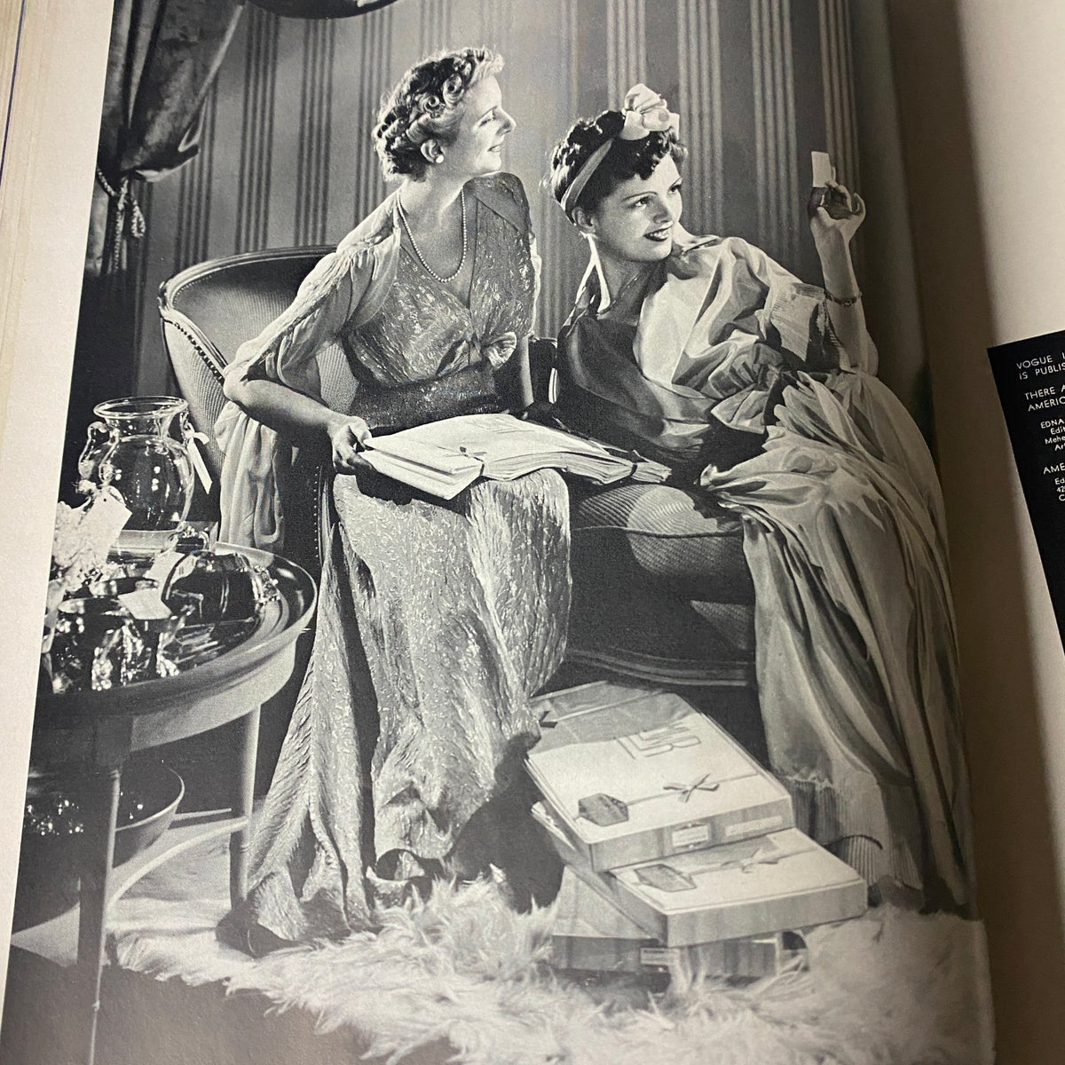 Black and white photograph from inside Vogue Magazine April 1, 1939, featuring two elegantly dressed women, epitomizing the glamour and style of the era.