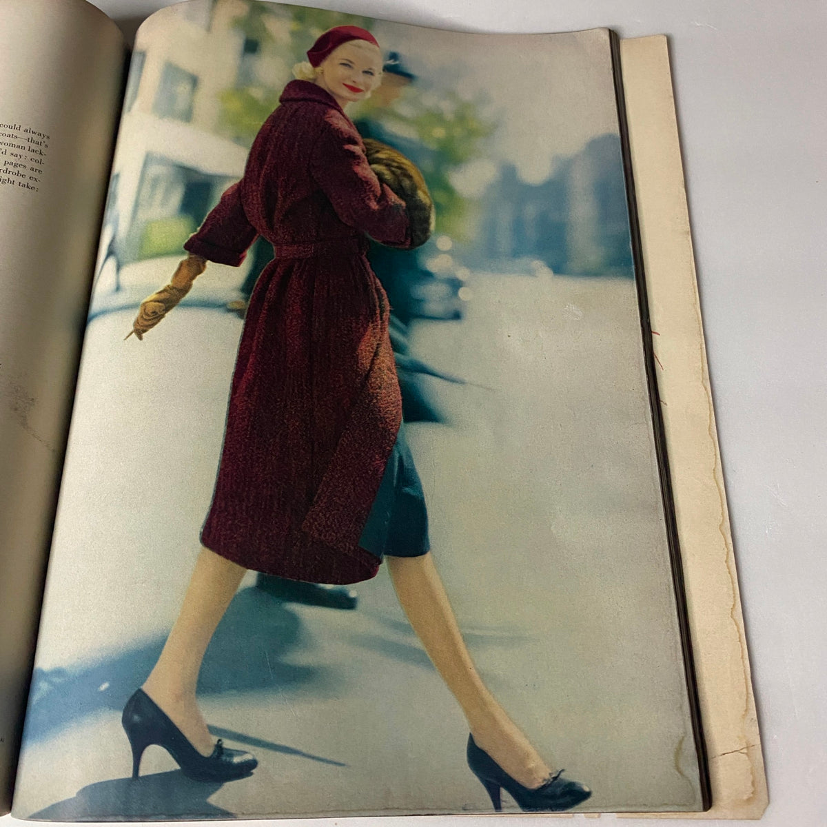 Vogue Magazine October 1, 1957 Mary McLaughlin Cover by William Klein, depicting a stylish woman in a maroon coat walking on the street, embodying the fashion sophistication of the late 1950s.