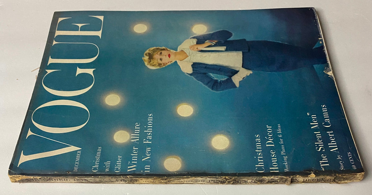 Side view of Vogue Magazine December 1957 Gyongyi Armstrong Cover by Karen Radkai displaying seasonal fashion highlights, including Christmas and winter allure.