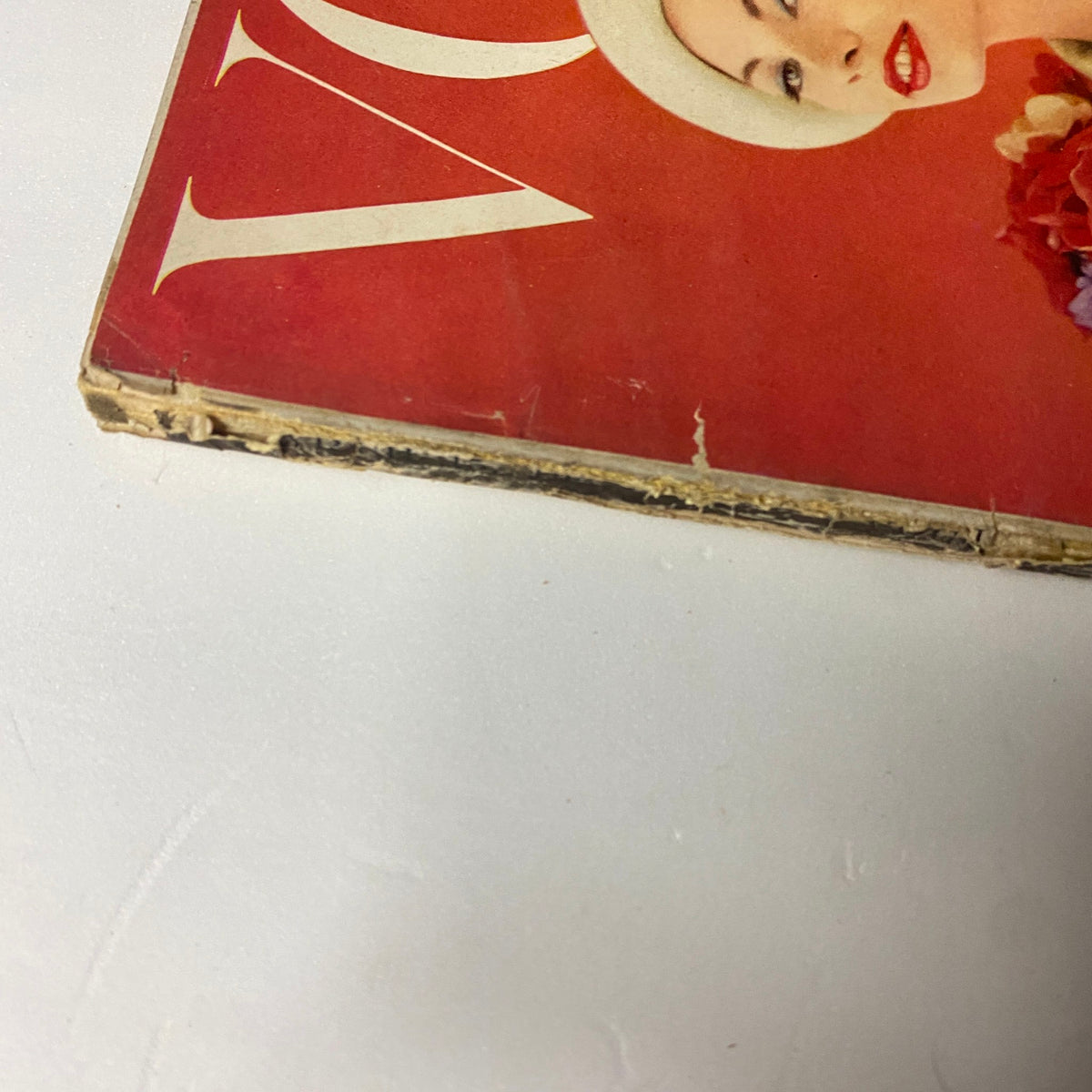 Close-up of the cover of Vogue Magazine March 15, 1957, featuring Jessica Ford, photographed by Karen Radkai. The vintage magazine shows visible wear at the edges, characteristic of its age.