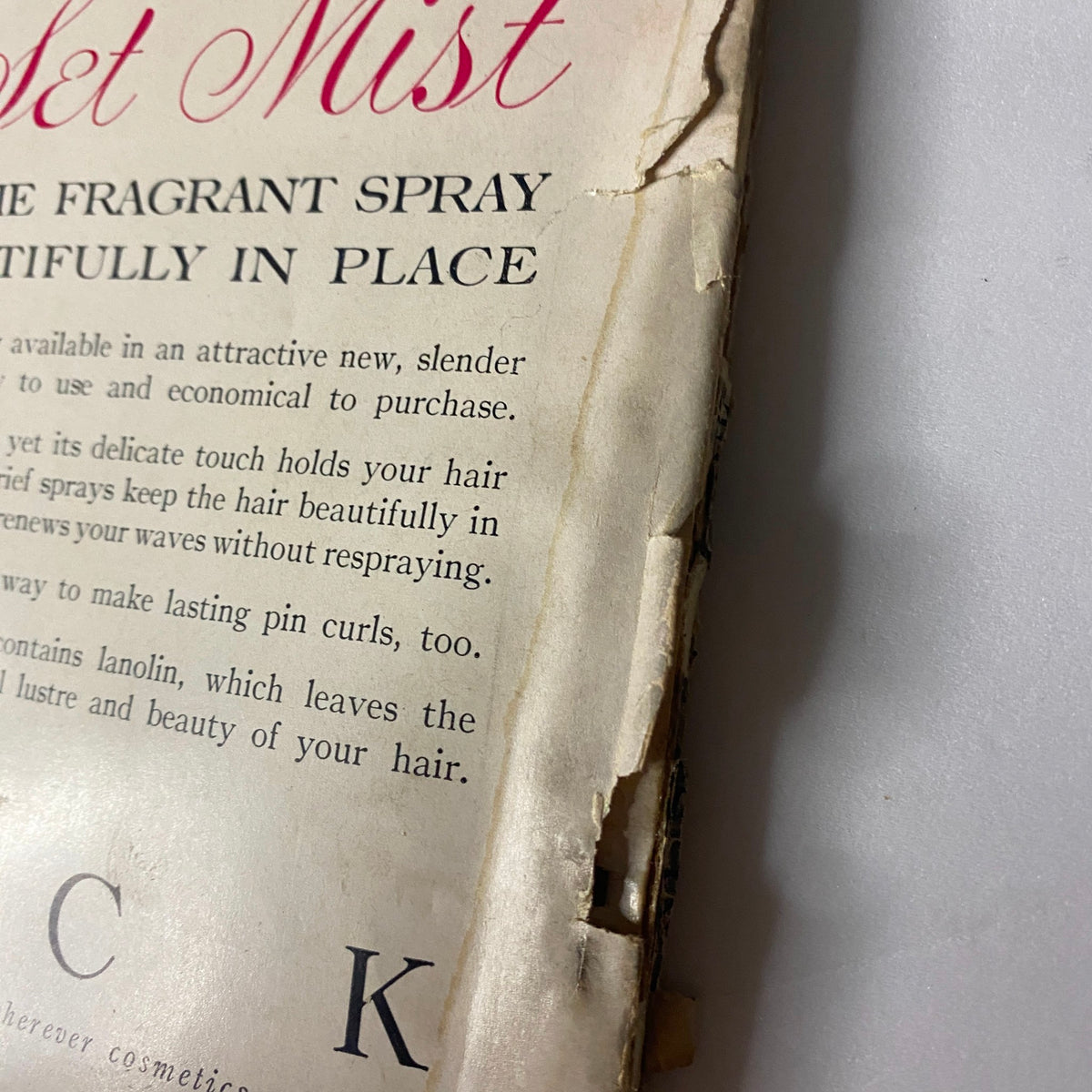 Detail of a vintage advertisement from Vogue Magazine March 15, 1957 for Breck Hair Set Mist, featuring information about the product's benefits for hair styling.
