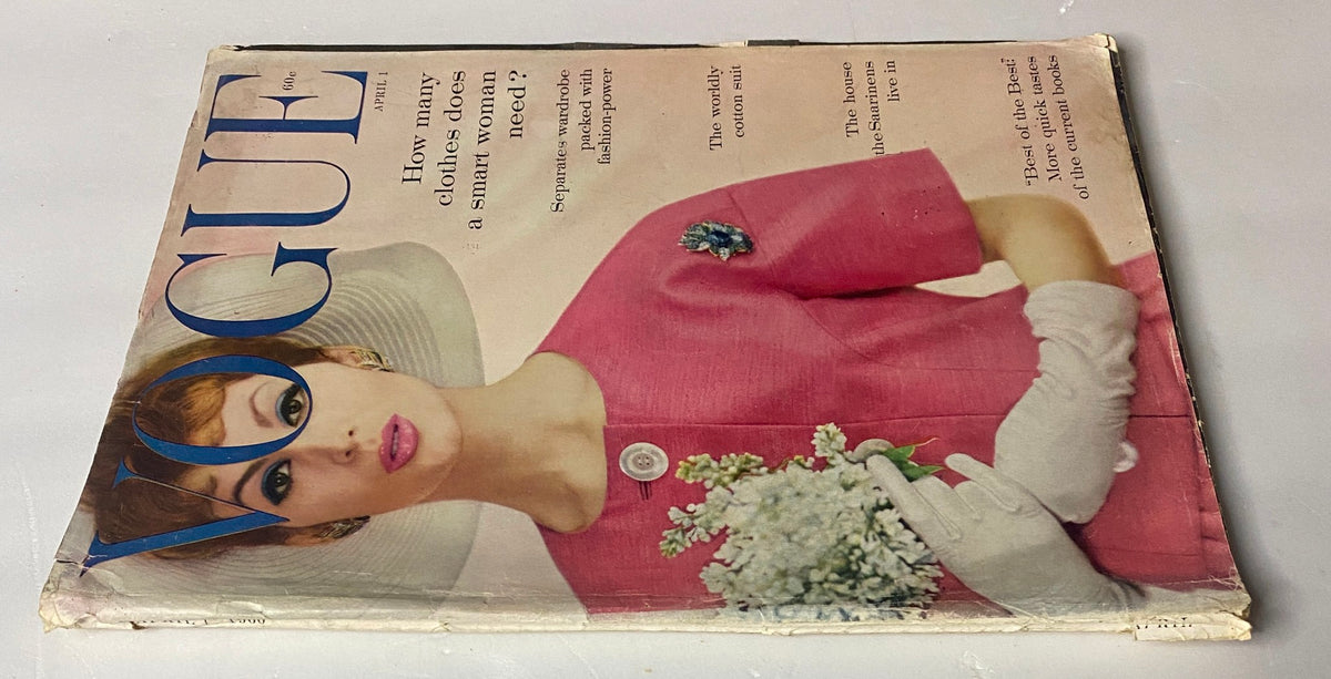 Vogue Magazine April 1, 1960 displayed at an angle, featuring a close-up view of the pink dress and model, highlighting vintage fashion from the 1960s.