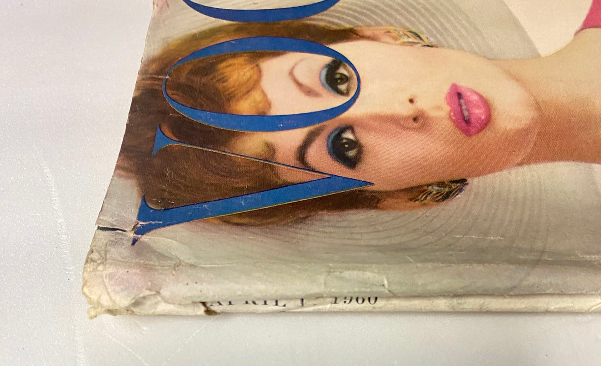 Detail of Vogue Magazine April 1, 1960, capturing the magazine's corner with model's face and hairstyle, emphasizing the vintage aesthetic of mid-century fashion.
