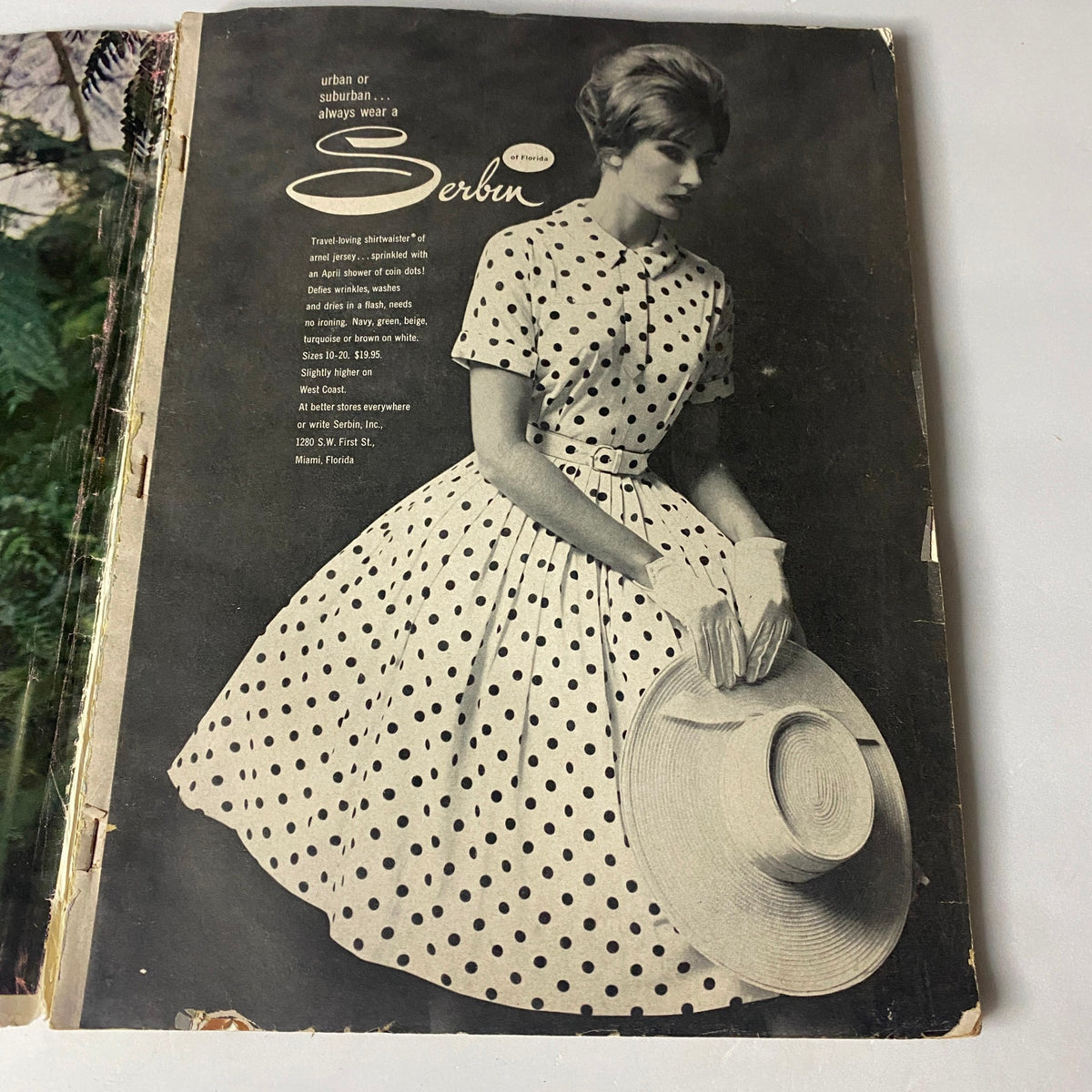Ad featuring a model in a polka dot dress from Vogue Magazine April 1, 1960, illustrating classic mid-century styles.