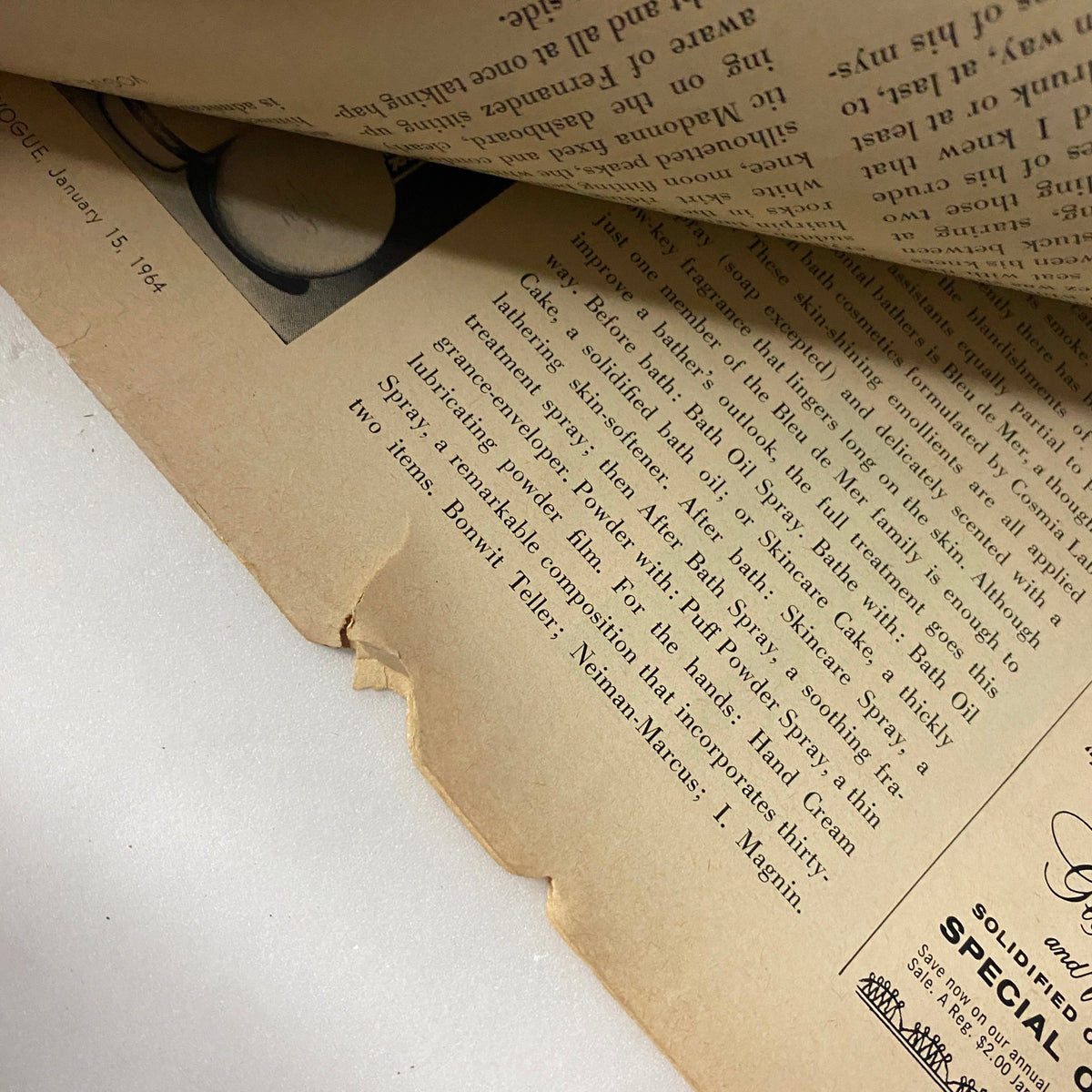 Vintage page from Vogue Magazine January 15, 1964 featuring text layout and slight wear, highlighting the wear and age of the publication.