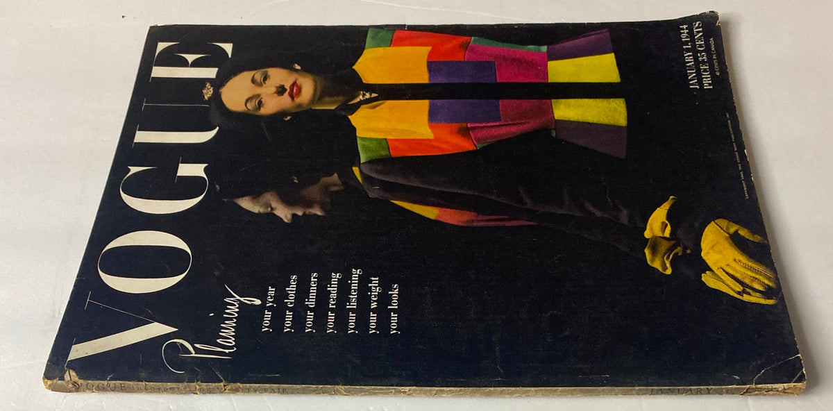 Close-up view of the Vogue Magazine January 1, 1944 cover, emphasizing the model's colorful outfit and the magazine's title, reflecting wartime fashion and planning.