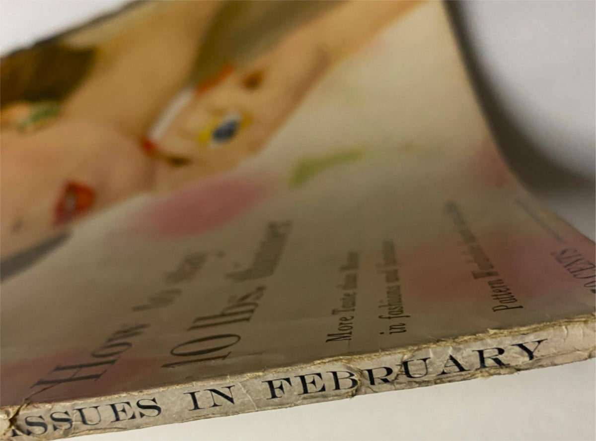 Close-up of the edge of Vogue Magazine February 15, 1957, displaying historical wear and the magazine's authenticity as a collectible piece from the 1950s.