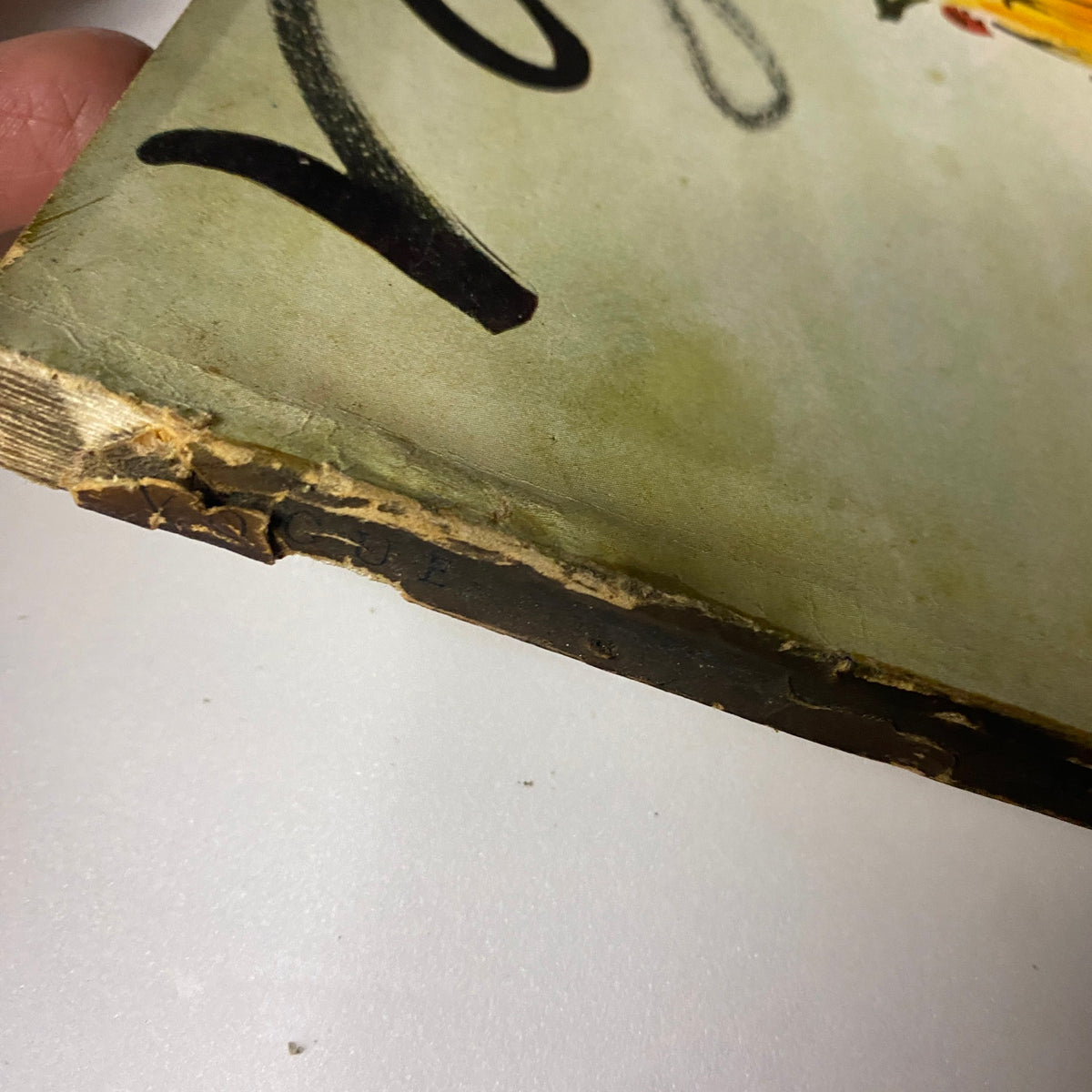 Side view of Vogue Magazine March 15, 1938 showing wear on the spine, highlighting its vintage condition as a collectible item.