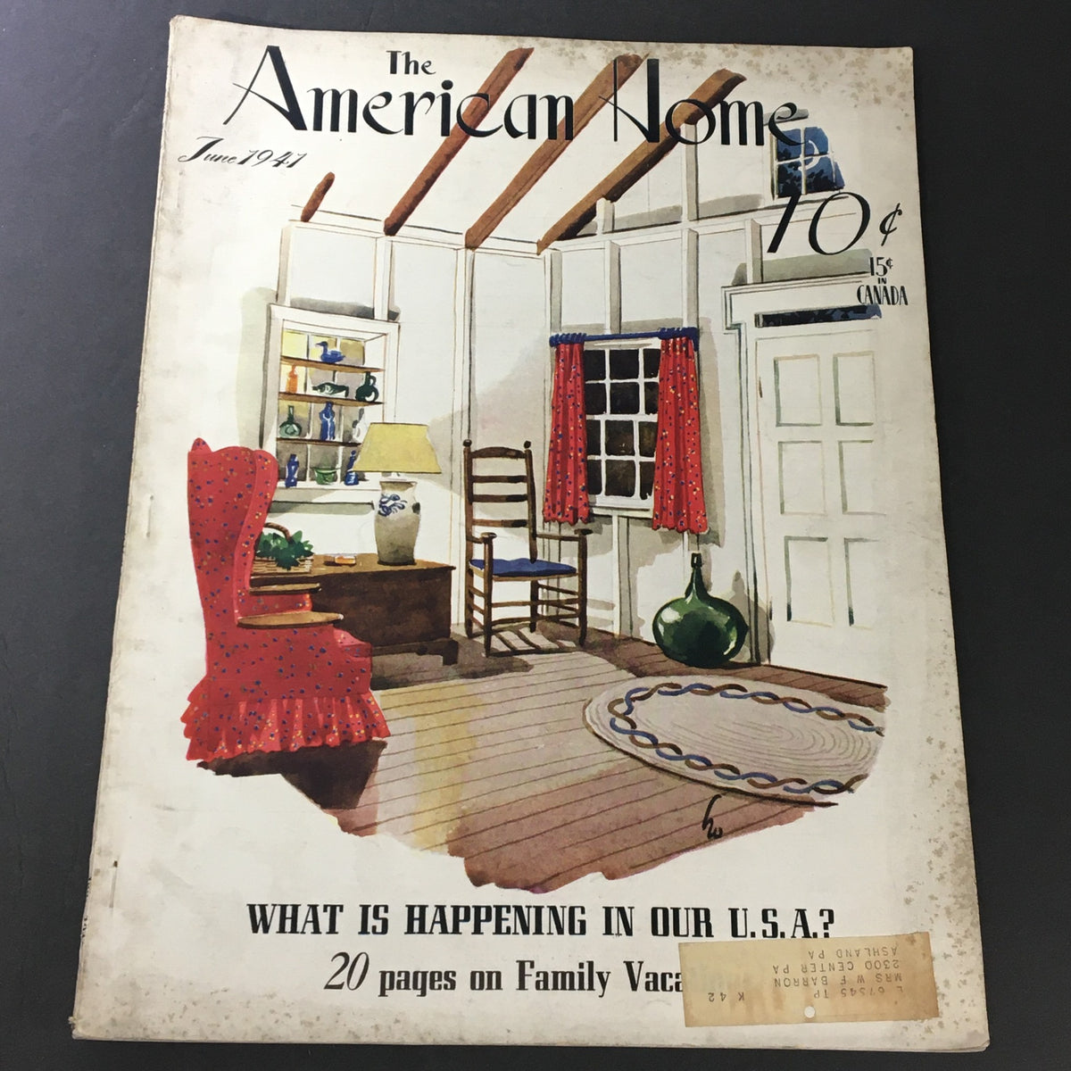 Cover of VTG The American Home June 1941 magazine showcasing a cozy interior scene with a vintage red chair, a wooden table, and decorative elements. The title 'The American Home' and the issue date 'June 1941' are prominently displayed, highlighting a nostalgic glimpse into American domestic life.