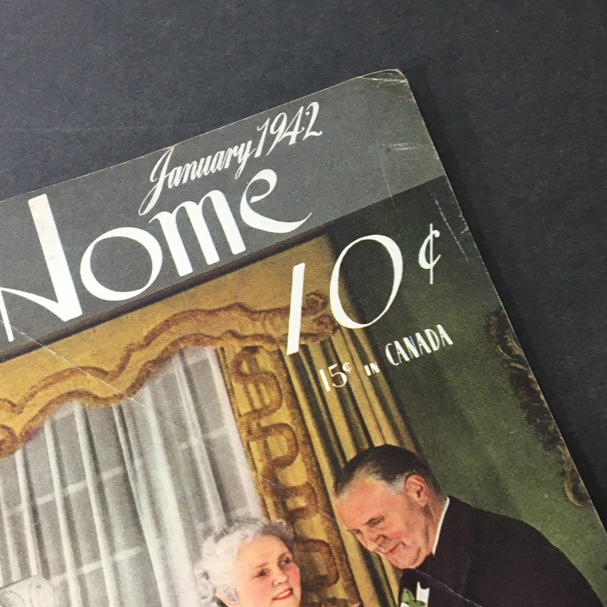 Cover of VTG The American Home January 1942 magazine featuring the title in elegant typography, showcasing a vintage style with a couple elegantly dressed.
