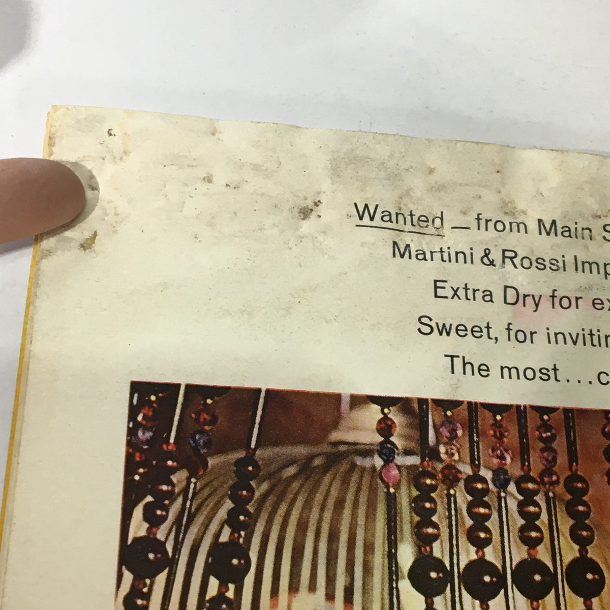 Close-up of the back cover of VTG Newsweek Magazine from March 21, 1966 highlighting details from the Martini & Rossi advertisement, illustrating signs of wear and character.