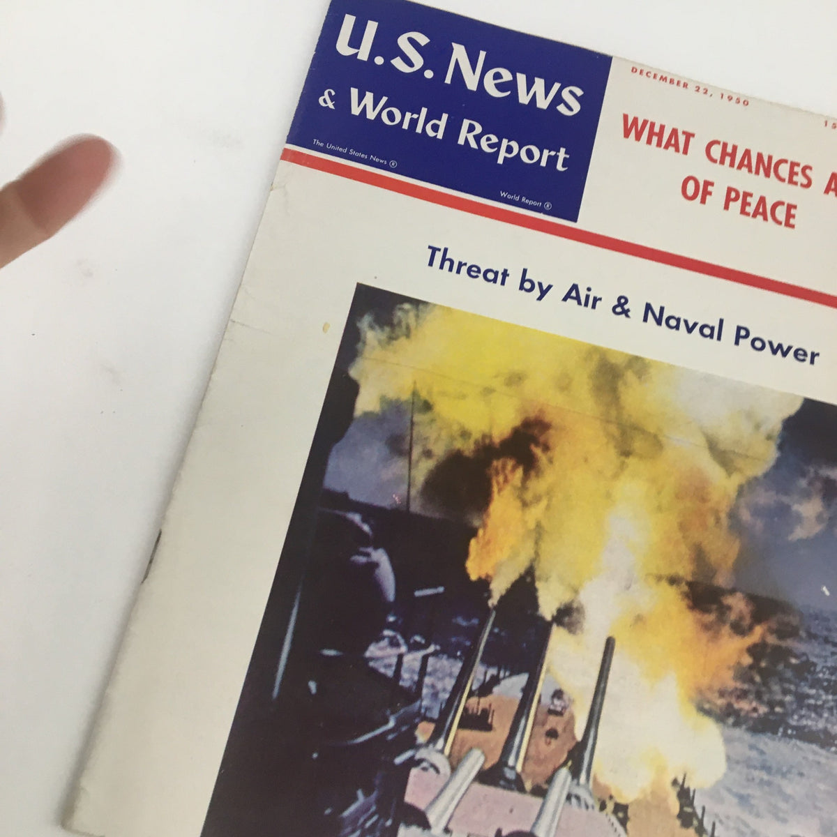 Cover of the vintage U.S. News & World Report from December 22, 1950, featuring a dramatic image of naval power with smoke and flames, discussing the theme 'Threat by Air & Naval Power.'
