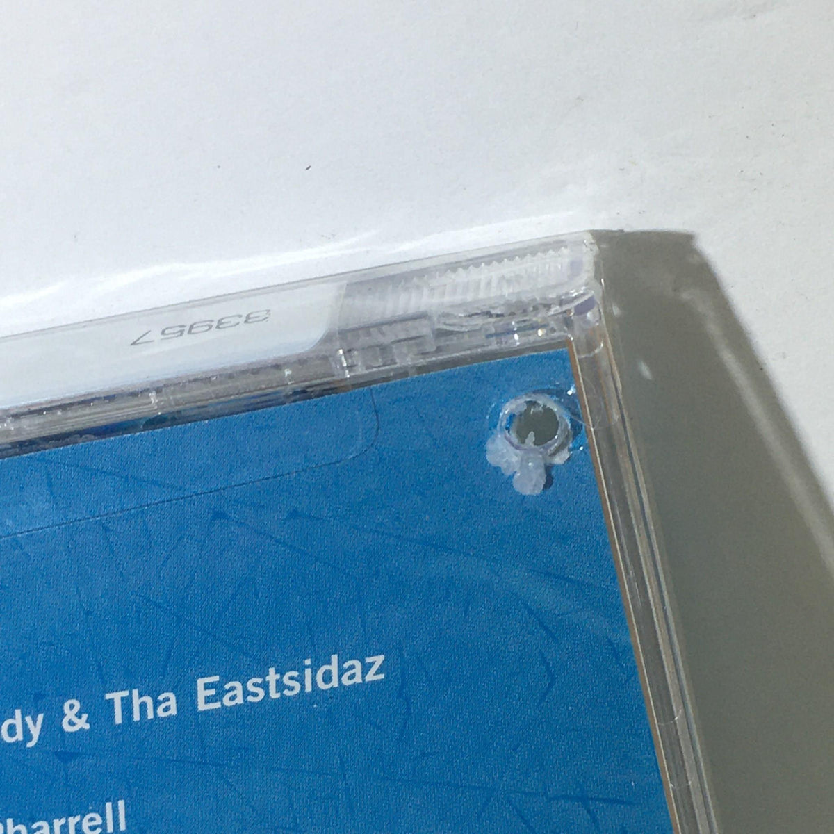 Close-up of The Best of Snoop Dogg Music Audio CD with a visible hole in the case indicating it is a cut-out copy.