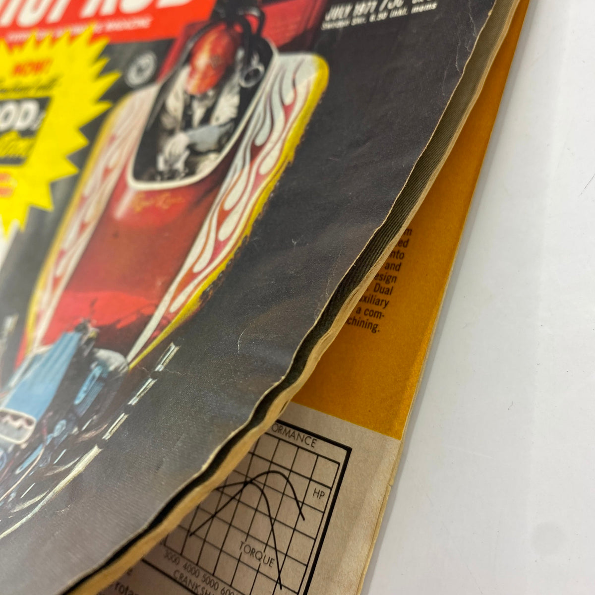 Close-up view of VTG Hot Rod Magazine July 1971, showing the magazine's edge, highlighting wear and features like the title and graphics.