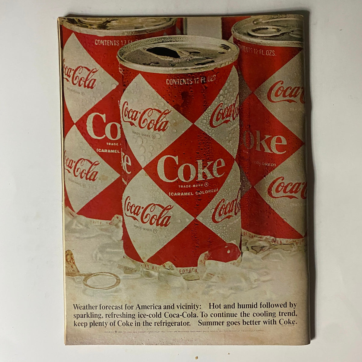 Coca-Cola advertisement from Motor Trend Magazine September 1969, depicting classic Coke cans, reflecting the vintage charm of the era.